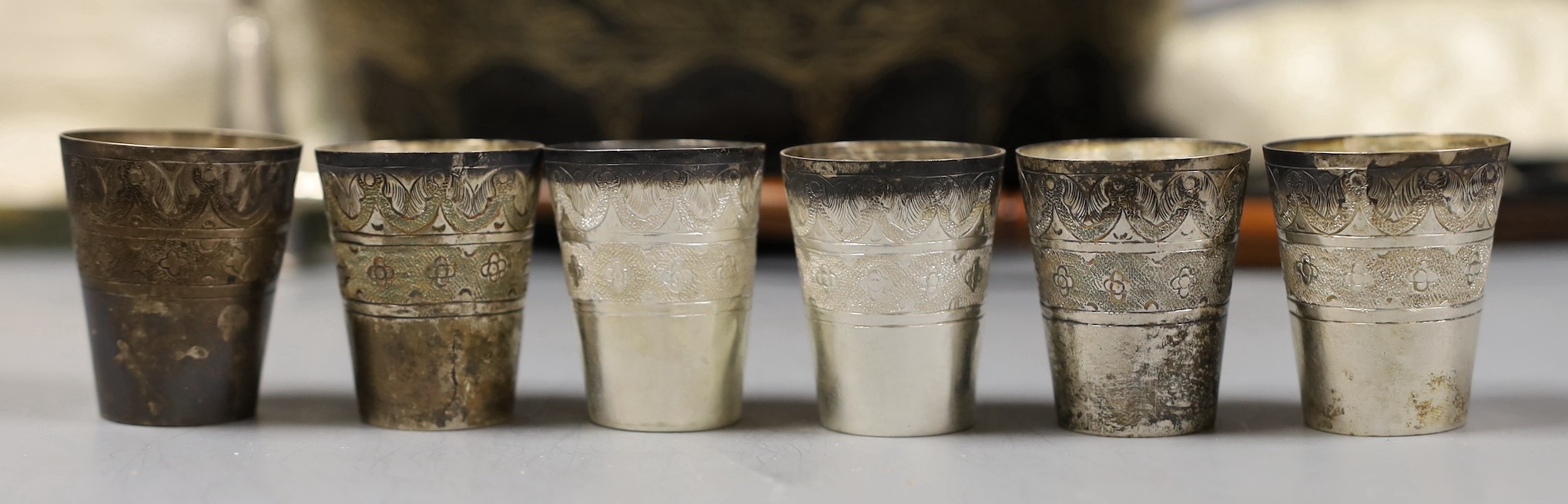 Assorted silver and other items including two silver mounted photograph frames, a Georgian silver mustard by John Eames, a graduated suite of three Victorian silver mounted horn beakers, a silver candle extinguisher, a c